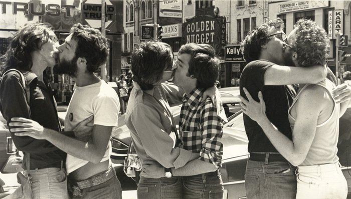 Kiss-in on Bloor Street, Toronto, July 17, 1976. Photo by Gerald Hannon. The ArQuives, accession 1986-032/155P. Features 3 homosexual couples kissing.