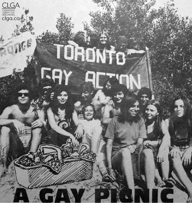 a photograph from the picnic in 1971, with a group of individuals sitting at Hanlan’s point, holding a “Toronto Gay Action” poster