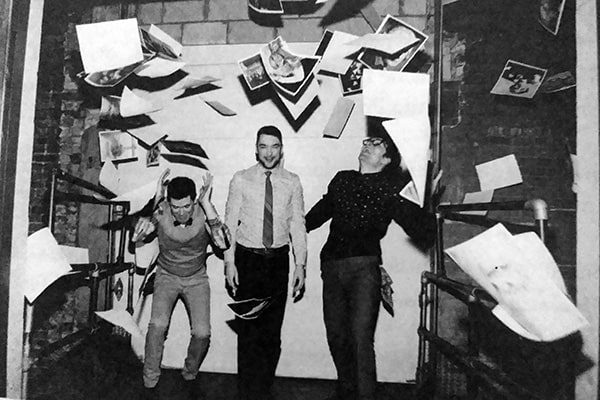 black and white photo of the three playwrights with papers flying around their heads.