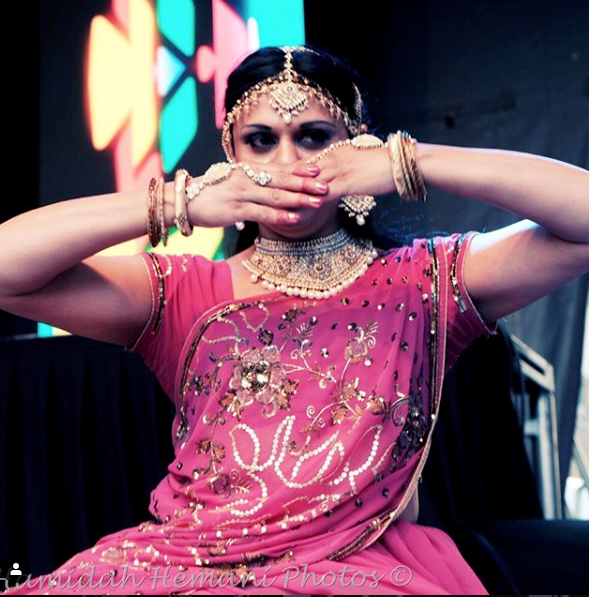 Hemidah Hemani photograph a south Asian performance artist dancing at Church and Wellesley Street, June 2019 at Toronto Pride. © Hemidah Hemani