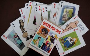 Queer Pin-Ups playing cards spread out on top of a table.