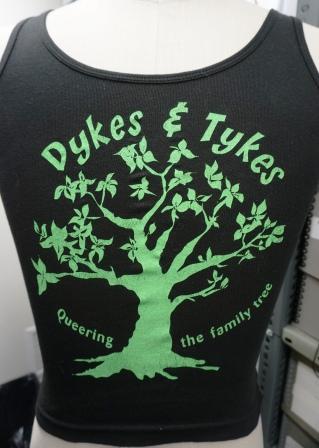 black t-shirt with Dykes & Tykes in green, front