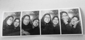 Black and white photo booth photo of two people making faces