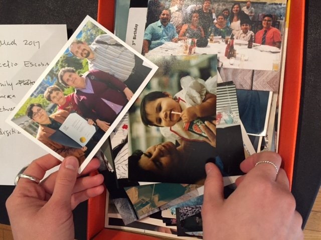 Hands holding family photographs