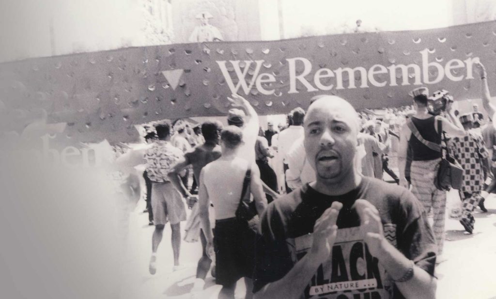 man in front of We remember banner